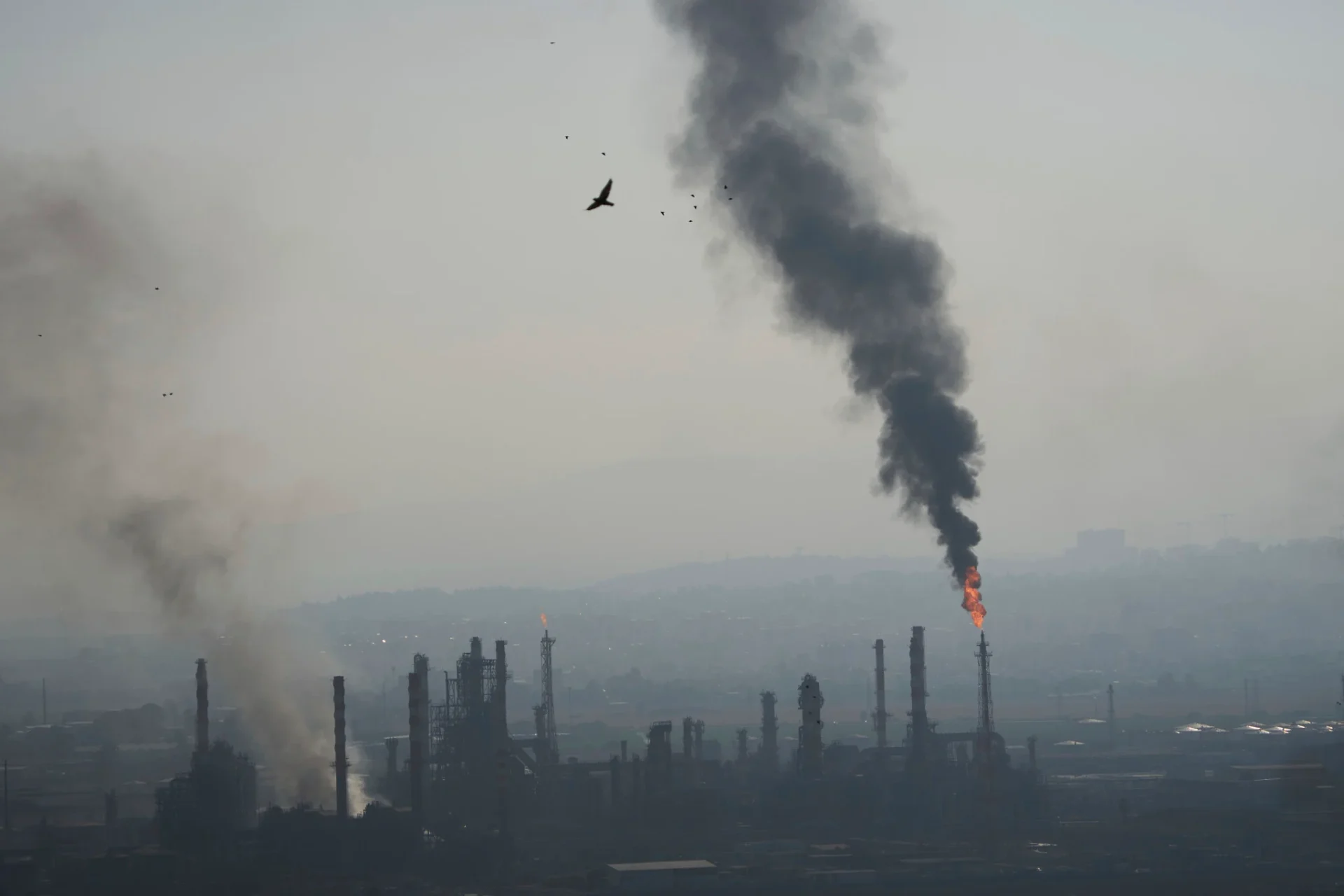 Smoke billows after an Iranian missile struck an oil refinery in Haifa, northern Israel, early June 16, 2025 (PHOTO: AP/Ariel Schalit/The Times of Israel/THE EDITOR)