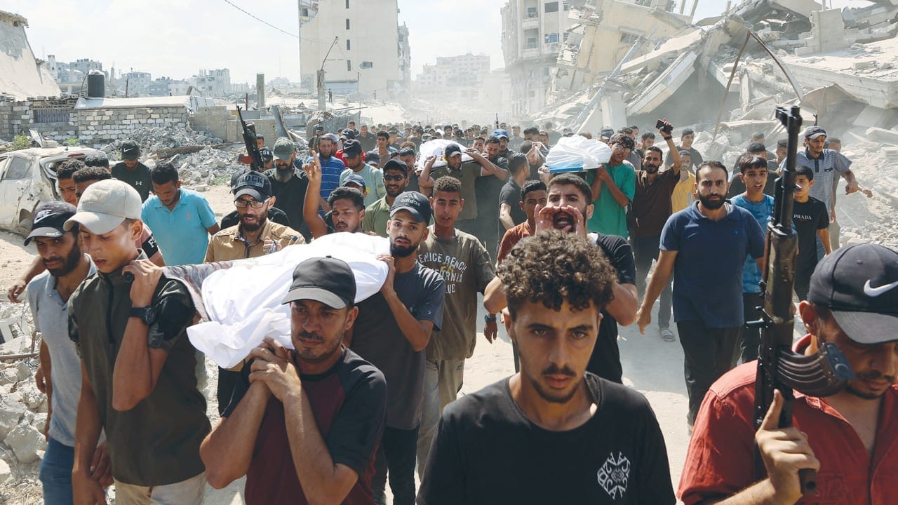 THERE ARE indications in Israel that the mood is shifting away from a robust embrace of the conflict. Here, mourners carry the body of a Palestinian, killed the night before in an Israeli strike, during their funeral in Gaza City on Tuesday (PHOTO: Omar Al-Qattaa/AFP via Getty Images/TNS/The Jerusalem Post/THE EDITOR)