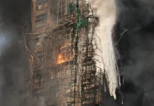 What is Bamboo Scaffolding and How Did It Worsen The Hong Kong Fire? Smoke rises while flames burn bamboo scaffolding and green netting on a building at Wang Fuk Court housing estate, in Tai Po, Hong Kong, November 26, 2025 [Tyrone Siu/Reuters/Al Jazeera )