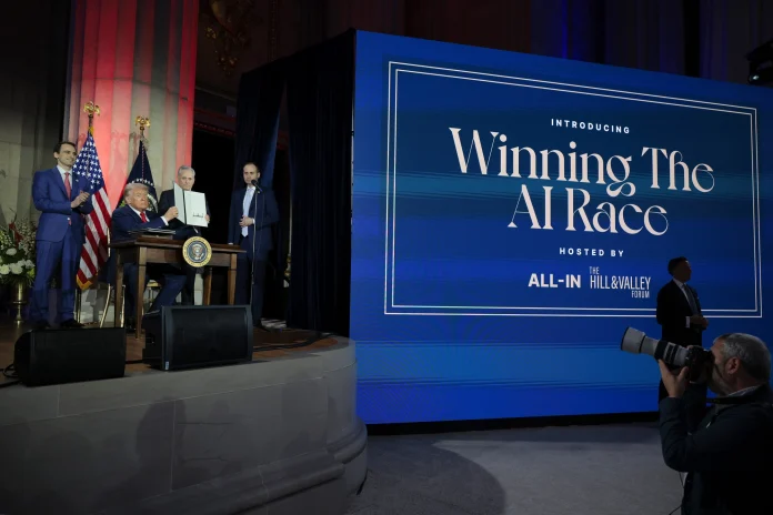 President Donald Trump displays a signed executive order during the “Winning the AI Race” summit on July 23, 2025, in Washington. (Photo: Chip Somodevilla/Getty Images/Politico)