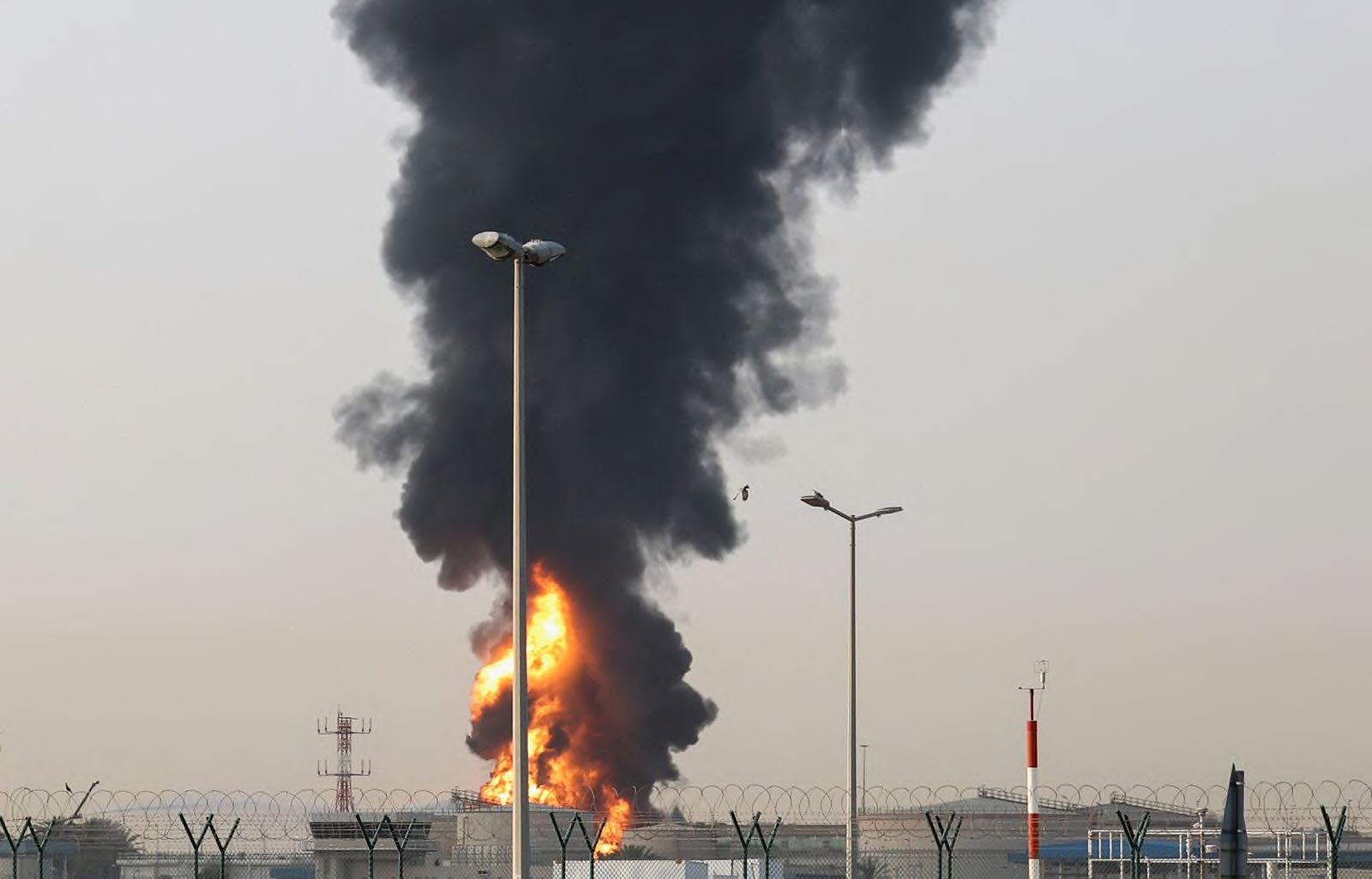 Smoke rises from an area near Dubai International Airport (DXB) in Dubai, United Arab Emirates, 16 March 2026, amid the US-Israel conflict with Iran. The Dubai Media Office reported a 'drone incident' in the vicinity of the airport that affected a fuel tank, igniting a large fire. Authorities temporarily suspended all flights at the airport as a precautionary measure; no injuries have been reported. Civil defense teams successfully contained the fire by morning (PHOTO: EPA/STRINGER)