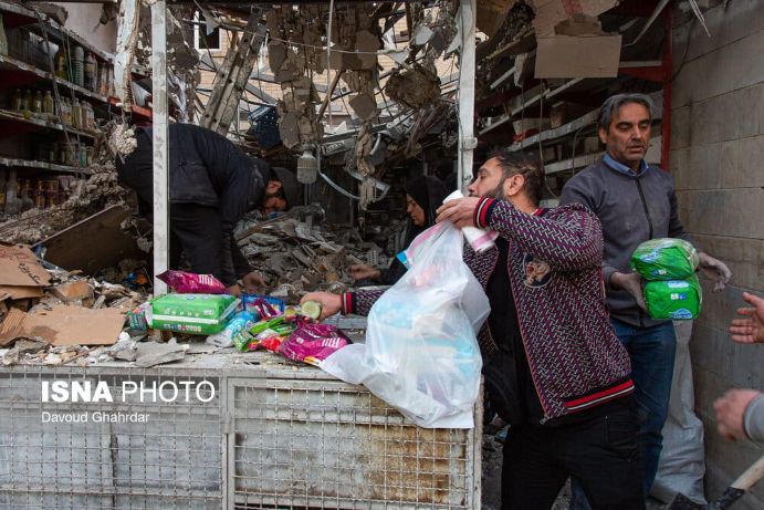 A shopkeeper in Tehran collects leftover goods after a missile attack. They were preparing for a New Year’s Eve sale (Photo: Davoud Ghahrdar/The Asian)